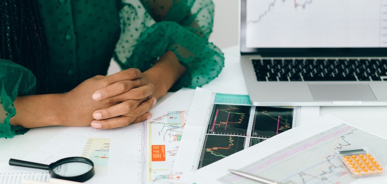 woman sitting in front of currency exchange graphs